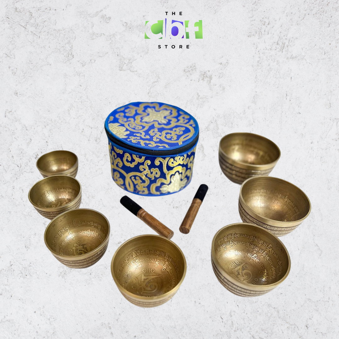 Carved chakra mantra singing bowls set in gold and various sizes of 7 bowls.